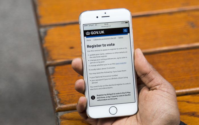 A mobile phone screen displaying the 'register to vote' page on the government website.