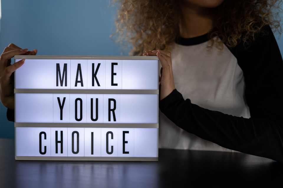 A cinma style light box sign, showing the words make your choice.