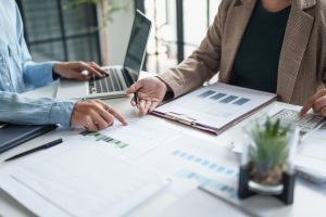 An accountant and a self-employed person looking over figures