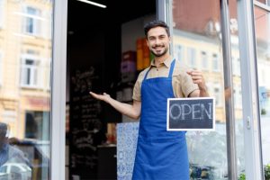 A self-employed man opening up his cafe
