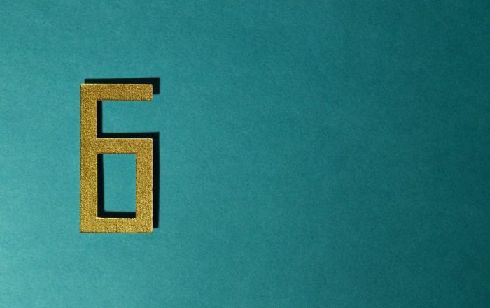 A number 6 cut from crafting paper against a dark turquoise background - signifying you ideally need 6 months to go through the remortgage progress